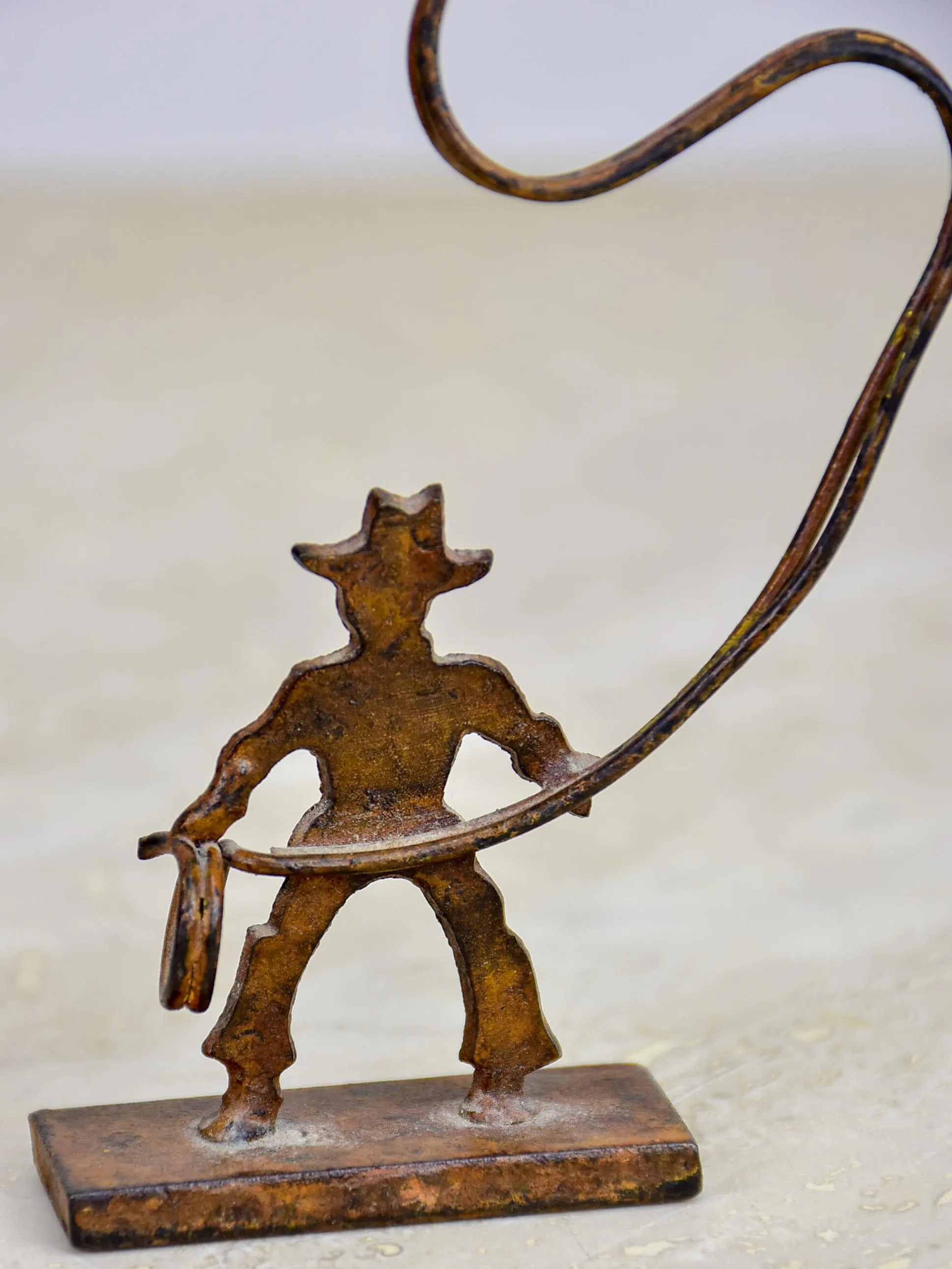 Antique cowboy lasso sculpture